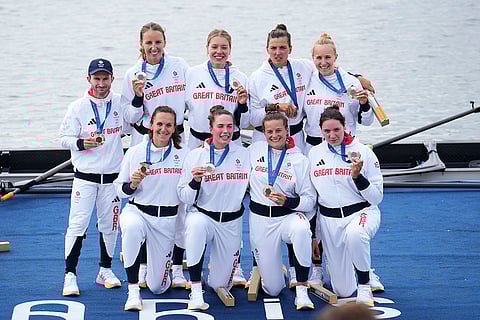 Women's eight rowing final: Britain's team pose after winning bronze